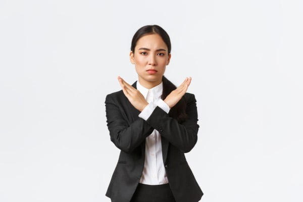 seriouslooking confident businesswoman black suit showing cross gesture forbid action restrict forbid prohibit making any deals stop working with client white background time out